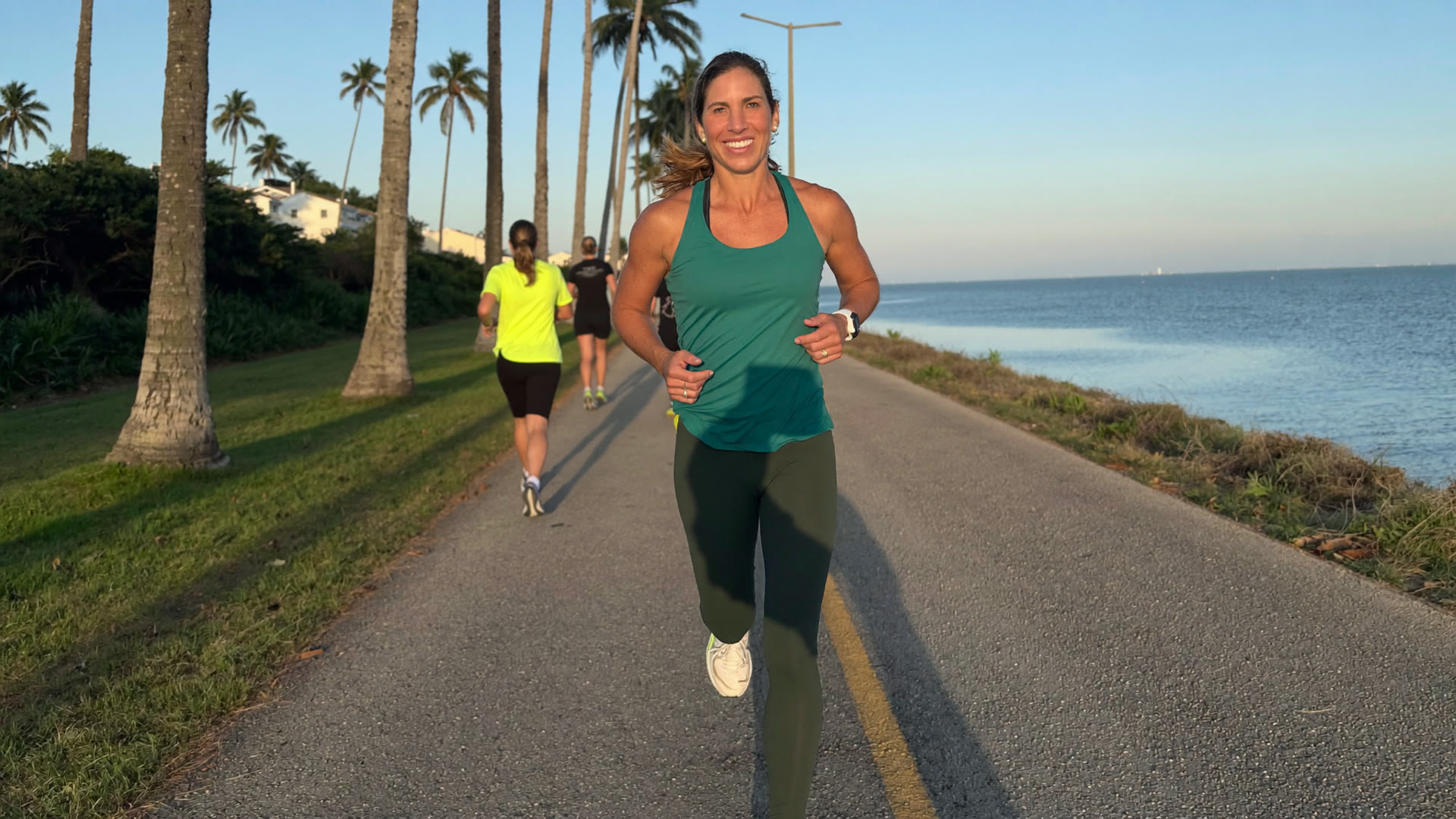 Andreina Carvallo leading a group of women over 40 on a sunrise run along the Miami waterfront